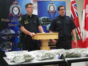 A joint effort with the Timmins Police Service and local provincial police has resulted in an arrest and the interceptions of nine pounds of marijuana. The drugs were on display during a press conference attended by OPP Const. Marc Depatie, left, and Timmins Police Const. David Ainsworth at the Timmins police station Thursday.