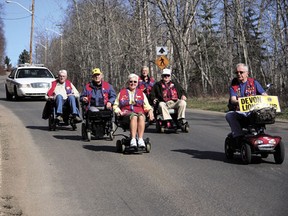Lions club members were out in the community this week, leading a wheelchair procession to the campground on Friday, May 3, and reading to students at Holy Spirit Catholic and Robina Baker Elementary Schools on Tuesday.