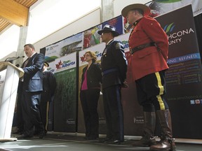 Andre Corbould, the Alberta Transportation assistant deputy minister, speaks about route safety while surrounded by law enforcement officials during a Tour of Alberta news conference at Strathcona Community Centre in Sherwood Park, Alta., on Friday, May 3, 2013. The six day international pro cycling event runs across from Sept. 3 to 8, 2013.