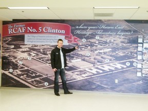 Andrew Oud, of Vanastra Packaging, poses in front of the historical mural of the former RCAF No. 5 Clinton base which is now the Village of Vanastra, at the London International Airport.
