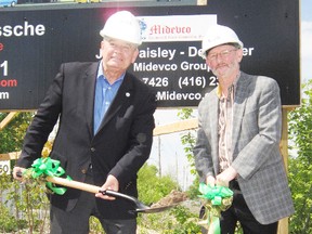 MONTE SONNENBERG Simcoe Reformer 
Heavy equipment is about to roll on the former American Can property in downtown Simcoe. Turning the sod on the $19-million opening phase Thursday were Norfolk Mayor Dennis Travale, left, and John Paisely of the Burlington developing firm Midevco.