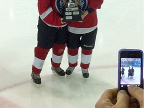 Sherwood Park Bantam AAA Royals players Cara Batey and Tristin Arndt display the championship trophy after helping the North Red Wings capture the recent ATB Alberta Challenge tournament in Medicine Hat. Photo supplied