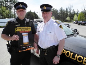 SARAH DOKTOR Simcoe Reformer
Norfolk County Const. Ed Sanchuk and Staff Sgt. Rob Scott hold a banner for a prescription drug drop off day on Saturday  between 10 a.m. and 3 p.m. at the Norfolk County OPP detachment in Simcoe.