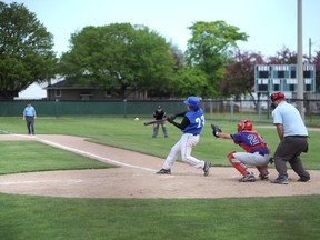 Sarnia Collegiate's Derek Williams drives a ball to center field for a base hit as the Blue Bombers took on the St. Clair Colts at Errol Russel Park Thursday in LSSAA boys baseball. Dylan Whitbread catches for the Colts. The two teams tied 6-6. (BLAIR TATE, For the Observer)