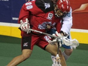 Sarnia's Jimmy Purves, in white, of the Rochester Knighthawks battles with Calgary Roughneck Travis Cornwall in action earlier this season. Purves and his Rochester teammates play the Washington Stealth for the NLL championship Saturday. (MIKE DREW, QMI Agency)