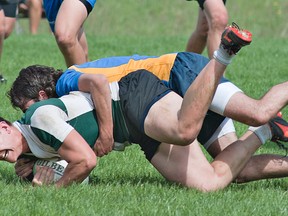 Jason LeBlanc of St. John's grimaces as he's tackled by a BCI player during a high school senior boys rugby match on Thursday afternoon at George Jones Fields. (BRIAN THOMPSON, The Expositor)