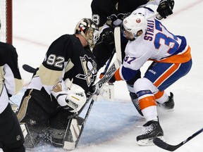 Penguins goaltender Tomas Vokoun makes a save on Islanders defenceman Brian Strait during Game 5 of their NHL Eastern Conference quarterfinal at the Consol Energy Center in Pittsburgh, May 9, 2013. (JASON COHN/Reuters)