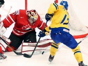 Sweden's Fredrik Pettersson tries to score on Canada's goalie Mike Smith during a World Hockey Championship preliminary-round game at the Globe Arena in Stockholm Thursday. (Arnd Wiegmann/Reuters)