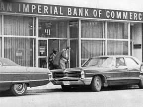 Kenora Police constable Don Milliard and masked bandit leave the CIBC bank on Main Street second before a police bullet strikes the robber, detonating the explosives he was wearing.
FILE PHOTO/Daily Miner and News