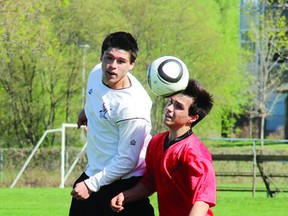 TINA PEPLINSKIE    The Fellowes Falcons' Tim Gorr (left) and the Equinoxe Patriots' Olivier Lavoie-Harvey go up to head the ball during senior soccer action at Riverside Park earlier this week. Gorr scored a goal to help Fellowes to a 4-0 win in its third game of the season.