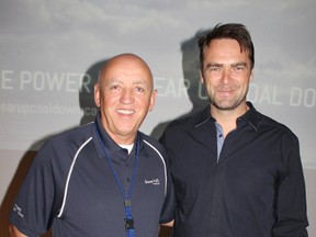 Bruce Power marked its 12th anniversary with a special breakfast with Toronto Maple Leaf goaltending legend Curtis Joseph on May 10, 2013 at the Bruce Power Visitors Centre. Guests took in a breakfast buffet and had pucks signed and photos taken with 'Cujo' before a special $100,000 donation to Keystone Residency Program in Owen Sound. Bruce Power president and CEO Duncan Hawthorne smiles for a photo with Joseph. (TROY PATTERSON/KINCARDINE NEWS)