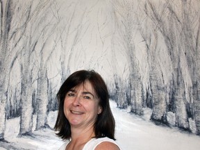 Local artist Laura Procunier poses by her piece Decades of Love in Song during the 54th annual Cochrane Art Club’s Spring Sale at the Ranche House May 4 and 5.