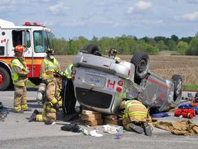 OTTAWA, ON (05/09/13): Ottawa paramedics and fire crews work to extricate a woman injured in a two-car crash on Prince of Wales Dr. in South Ottawa on Thursday afternoon. (Chris Hofley/Ottawa Sun/QMI Agency)
