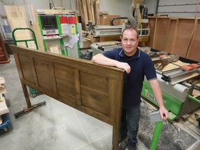 Mike Vokes, owner of Vokes Furniture  in Springmount, with one the company’s Louis Rustique headboards. The company is working with the Bluewater Wood Alliance to market their products in the Middle East. James Masters/The Sun Times.