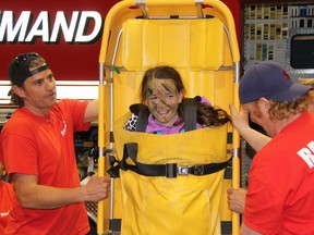 P.E. McGibbon student Jenna Duarte takes a ride on a backboard at Clearwater Arena Friday, May 10, 2013. More than 1,200 students, teachers and parents attended the eighth annual Emergency Preparedness Day event. (BARBARA SIMPSON, The Observer)