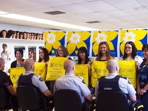 Four members of the Portage la Prairie RCMP shaved their heads for the Canadian Cancer Society, Friday, at the PCI hair salon after raising $3,000 for the organization. The members are pictured with hairstyling students and a representative from the Canadian Cancer Society (right). (ROBIN DUDGEON/PORTAGE DAILY GRAPHIC/QMI AGENCY)