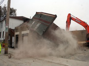 The old dry cleaner’s building next to The Standard Tavern on Pine Street South was pulled down early Thursday morning.
