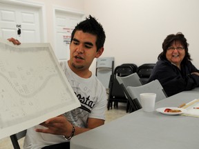 Len Cloud (left) talks to other participants at an arts workshop Friday about a drawing he was inspired to create from a recording of a First Nations treaty. He was one of eight participants in the Drawing Treaty Workshop, led by Aboriginal artist Adrian Stimson at the Sarnia Lambton Native Friendship Centre. (BLAIR TATE, For the Observer)