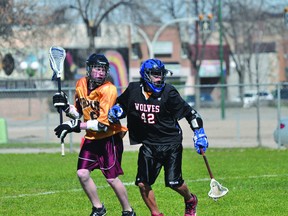Action from the PCI Trojans/Sagkeeng Wolves lacrosse game on May 10. The Trojans won 9-0. (Kevin Hirschfield/THE GRAPHIC)