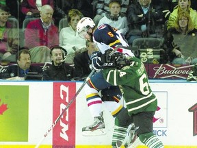 London Knights? forward Ryan Rupert checks Barrie Colts? defenceman Aaron Ekblad into the boards during Game 5 of their Ontario Hockey League championship series at Budweiser Gardens Friday. The Knights won 6-4 but trail 3-2 in the series.  (CRAIG GLOVER, The London Free Press)
