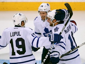 Toronto Maple Leafs' Clarke MacArthur (right) celebrates his goal on the Boston Bruins with teammates John-Michael Liles and Joffrey Lupul during Friday night's game in Boston. (REUTERS)