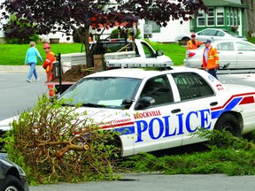 City of Brockville employees help clear the debris from the scene of a collision between a Brockville police cruiser and a motorist at the intersection of Ormond Street and Front Avenue on Friday morning. (DARCY CHEEK The Recorder and Times)