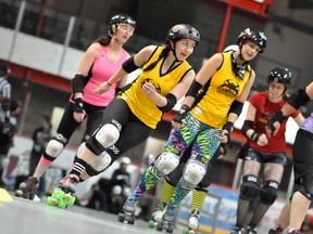 The Gold City Roller Girls held an open house on Saturday at the McIntyre Arena, where anyone interested in learning more about the sport was welcome to try it out. Derby girl Pamela “Lady Slam-a-lot” Reid, centre, skates around the track with dozens of people who came out to learn more about the sport.