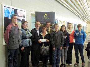 Mike Allen presents a cheque to board chair Tracy McKinnon and Holy Trinity Students.