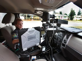 A Peace Officer operates a photo radar unit on 75 st and 92 ave in Edmonton, Alberta on April 23, 2013. Perry Mah/Edmonton Sun/QMI Agency