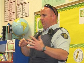 Mayerthorpe RCMP Const. Shaun Provost answers questions about policing in the Grade 4 class of Nolan Andriuk on Wednesday, May 8. Provost was invited to read to the class and tell them about his career and it was the second role that sparked the most interest. One of the students is the constable's daughter.