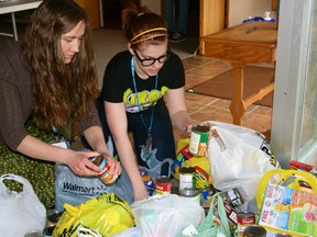 Zoe Yeomans, left and Jess Beachan, right, organize all of the food donated to the youth group's 30-Hour Famine door-to-door food collection. Relentless Youth Ministries of Lakeside Baptist Church participated in the World Vision event raising $3,200 and dozens of bags of non-perishable food items on Friday, May 10 and Saturday, May 11. 

GRACE PROTOPAPAS/KENORA DAILY MINER AND NEWS/QMI AGENCY