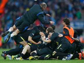 Wigan Athletic players and staff celebrate on the final whistle, as they defeat Manchester City in their FA Cup final soccer match at Wembley Stadium in London May 11, 2013.  (REUTERS)