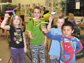 Jayda Giesbrecht, 8, left, her brother Anthony, 10, Evan Morhart, 6, and Jayden Assiniboine, 6, release their helicopters, which twirl their way to the ground during Lockdown at the Library Friday night. (CLARISE KLASSEN/PORTAGE DAILY GRAPHIC/QMI AGENCY)