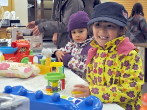 Sisters Loewen Hunter, 5, and Sienna Hunter, 4, with their parents, check out some of the toys for sale at the Royal LePage Shelter Foundation garage sale inside Portage la Prairie Mall Saturday. The event, hosted by the local Royal LePage real estate agency, raised money for the Portage Family Abuse Prevention Centre. (CLARISE KLASSEN/PORTAGE DAILY GRAPHIC/QMI AGENCY)