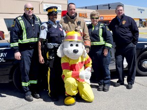 Portage la Prairie area emergency personnel came together Saturday to celebrate National Police Week at the Portage Mall Saturday. Pictured are paramedic Troy Adams, RCMP Const. Shannon Neff, firefighter Chris Perry, Sparky the mascot, paramedic Evelyn Green and firefighter Don Robertson. (CLARISE KLASSEN/PORTAGE DAILY GRAPHIC/QMI AGENCY)