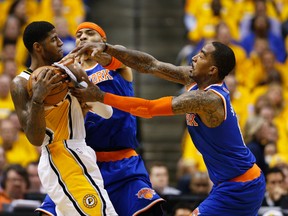 Paul George (left) of the Indiana Pacers battles for the ball with J.R. Smith and Kenyon Martin of the New York Knicks during Game 3 of the NBA Eastern Conference semifinals May 11, 2013 in Indianapolis.
(Joe Robbins/Getty Images/AFP)