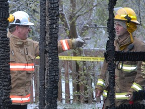 Insp.Dan Fraser (third from left) speaks to firefighters at the scene of a garage fire at 342 5th Ave. on Sunday, May 12, 2013.