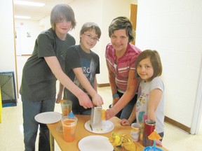 Grating cheese for nachos in teacher Leslie Cowley’s no-bake cooking options class are, from left, Wyatt Sandborn, Grade 6, Daniel Paquette, Grade 5, Chloe Williamson, Grade 6, and Sarah McCallum, Grade 4.