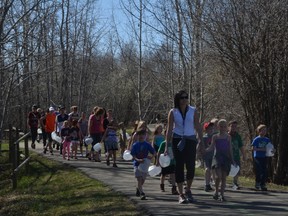 Grade 2 students from High Park School in Stony Plain make their way to the pond to fill up their milk jugs with water for the We Walk 4 Water initiative on May 6. - Thomas Miller, Reporter/Examiner