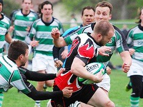 Belleville Bulldogs ballcarrier, Shaun Arbuckle, runs into a pair of Toronto Saracens defenders during TRU Men's A Division rugby action Saturday at MAS Field 3. (Chris Malette/The Intelligencer)
