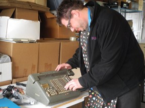 Syd Bolton, curator of the Personal Computer Museum, examines a 1950s-era Friden mechanical calculator dropped off during the museum's spring cleanup event on Saturday. (Heather Ibbotson, The Expositor)