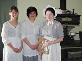 Brantford Collegiate Institute students Azra Alagic (left), Melissa Martin and Hannah Ruby dress in period costume to act as historical interpreters on Sunday at the Bell Homestead. They were among 18 BCI students who helped greet visitors enjoying a Mother's Day brunch at the Bell Homestead Cafe. (Heather Ibbotson, The Expositor)