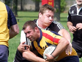 Kent Havoc ball-carrier Mike Lindsay runs into a Stratford Black Swans player during a 20-20 exhibition tie Saturday at Glen Mickle Park in Wallaceburg. The Havoc begin the Niagara Rugby Union regular season with a home game Saturday, May 25, in Chatham. (DAVID GOUGH/QMI Agency)