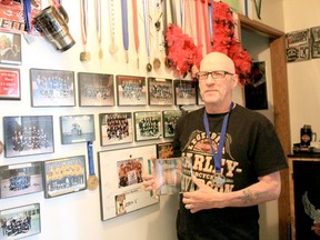 Drayton Valley ringette coach, and Ringette Alberta’s Coach of the Year, Ray Anderson proudly stands in front of his wall of honour that he’s built over the 18-years that he’s been coaching.