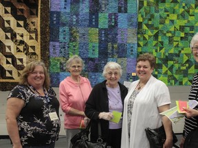 The third biannual Quilter’s Guild Open House was hosted in the Cold Lake High School (CLSH) gymnasium May 11.

“Every year we add a little more,” said Guild President Kim Fraser noting, “this year, we added the vendors, just to help more people come through and to spark it up a bit and we have door prizes, a sale table and a silent auction.”

The proceeds of the sale table and auction will be donated to the FASD Centre for the 2013 year -- Fraser explaining that a new charity is selected every year.
With 34 members, the Guild has seen steady growth over its years and shows no signs of slowing down.

Fraser noted “(the) guild has been running for many years now; we meet every second Wednesday of the month at North Star Elementary School (NSES) and the last Saturday of every month we have a ‘Quilting Day’ where we quilt like crazy.”

Left: “Labrynth Batik“ made by “Cathy“ and (right) a depiction of “Burgundy Paisley Double Irish Chain“ by Trudy Schouten are just a few of the wares that were on display at the May 11th event.

For more pictures, see page 33 and www.coldlakesun.com