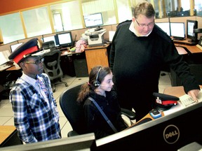 "If I were Chief of Police" essay contest winners Max Uhangho,10, and Stephanie Figueiredo, 11, get a crash course at the Chatham-Kent Police Service 911 Emergency Communications Centre from Brian French, Training Supervisor for the Communication Centre. (KIRK DICKINSON/FOR CHATHAM DAILY NEWS/ QMI AGENCY)