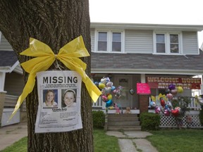 A missing person poster for Amanda Berry, one of the three woman found alive after vanishing for about a decade in their own neighborhood, is pictured on a tree in front of the home of Berry's sister, Beth, which is adorned with balloons and a welcome home banner for Amanda, in Cleveland, Ohio May 7. (REUTERS/John Gress)