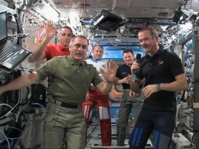 Canadian astronaut and International Space Station (ISS) Commander Chris Hadfield, right, hands over command to Russian cosmonaut Pavel Vinogradov (L) in this image taken from video shot May 12, 2013, courtesy of Chris Hadfield, NASA and CSA. Hadfield is preparing to return home on Monday after more than five months in orbit. REUTERS