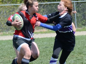 WALKERTON – Sacred Heart's Janelle Weber is tackled by the John Diefenbaker Trojan's Jordan Sharpe in the Crusaders' 29-17 win on Monday in Bluewater Athletic Association senior girls rugby play.
