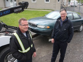 Rob Pantrey, left,  of Jack's Towing with Bob Abrams of the Southern Frontenac Community Services Corporation with a car ready to go to the wreckers.
Ian MacAlpine The Whig-Standard